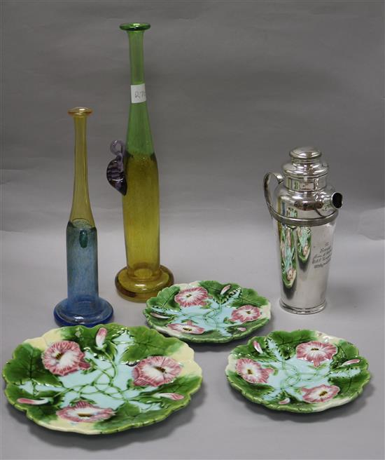 A plated cocktail shaker, plates and two studio glass vases